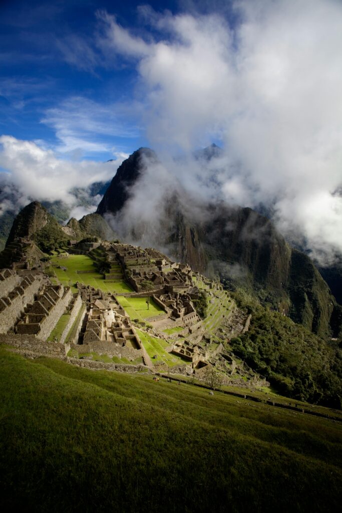 Viajes Personalizados y a Medida Breathtaking capture of Machu Picchu with dramatic clouds and mountains in Peru.